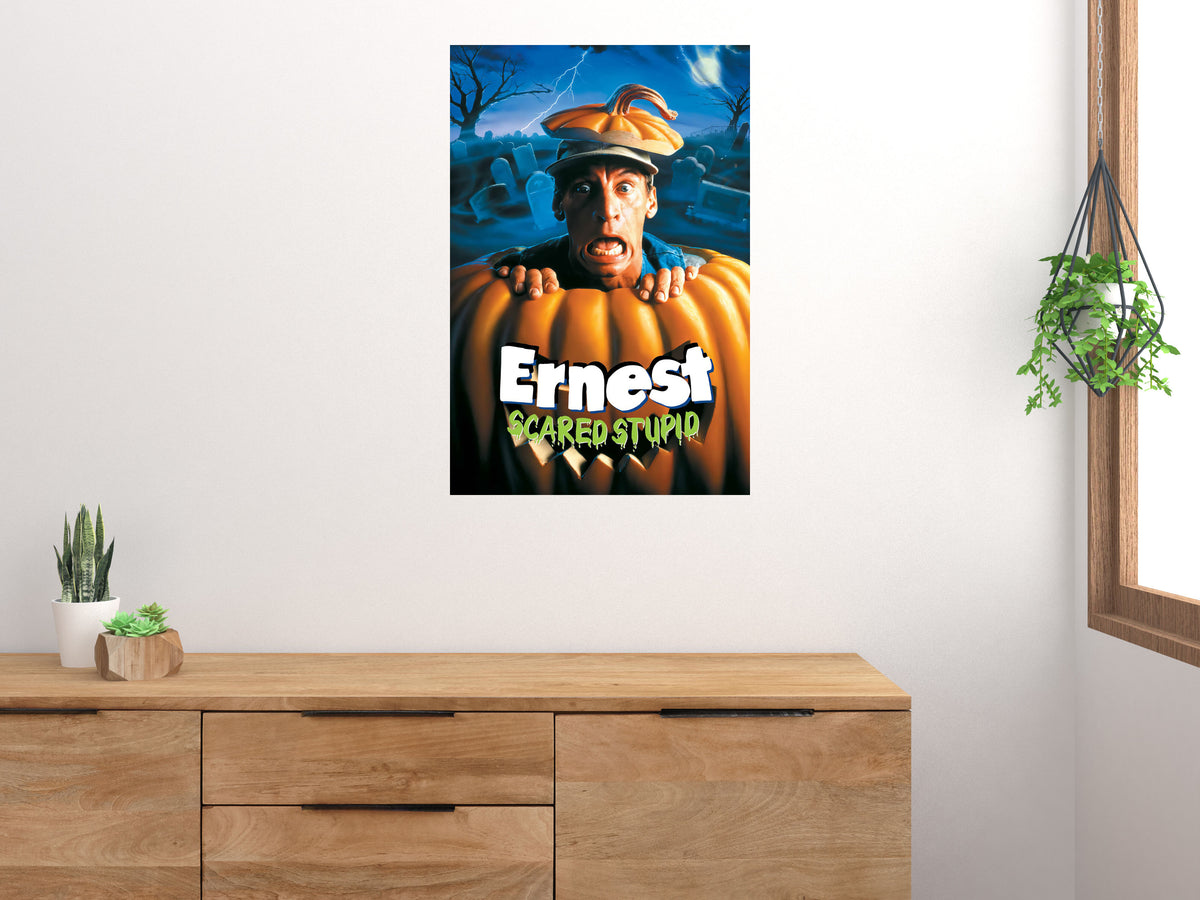 Ernest Scared Stupid vertical poster displayed on a light wall above a wooden cabinet