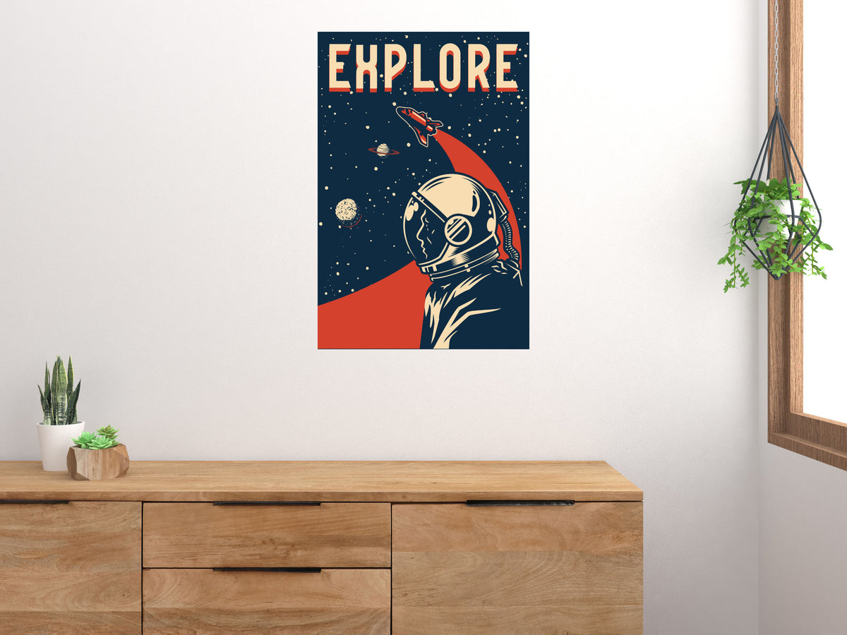 Explore Space astronaut poster displayed vertically above a wooden cabinet on a light wall