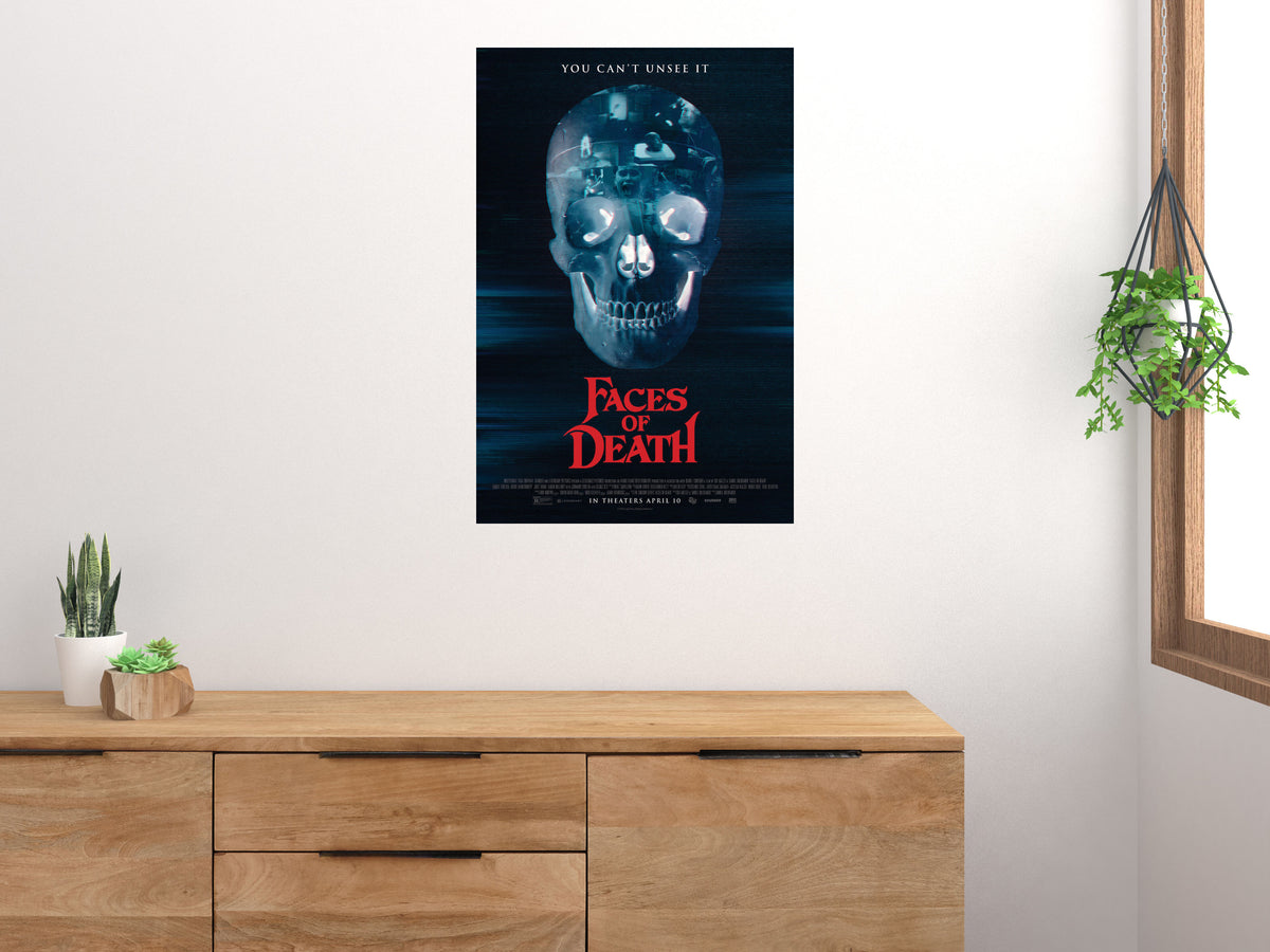 Faces of Death Blue Skull vertical poster displayed on a light wall above a wooden cabinet
