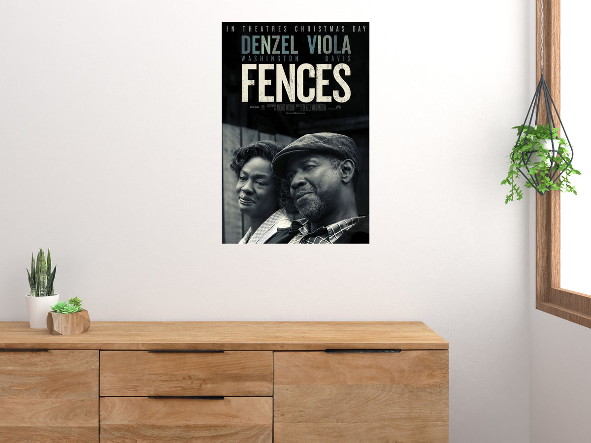 Fences vertical movie poster displayed above a wooden cabinet on a light wall