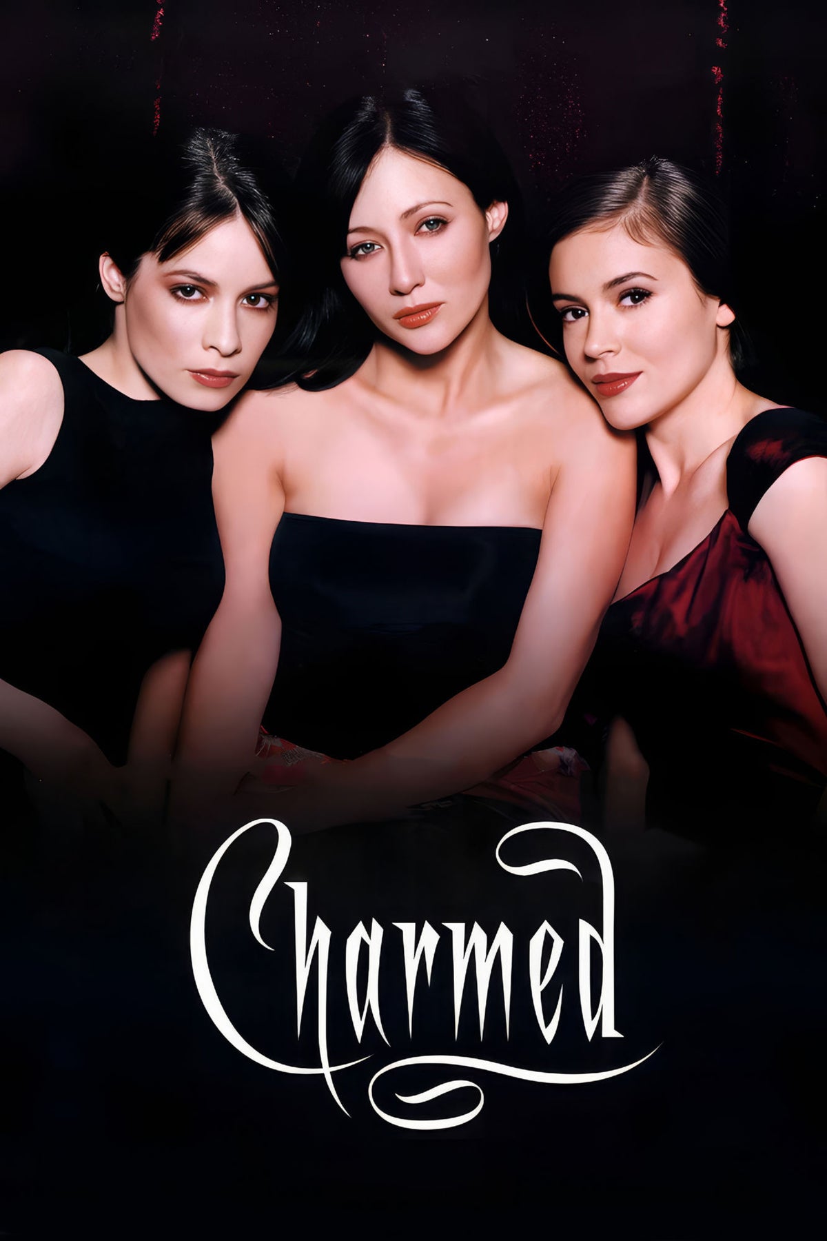 Charmed cast portrait poster with three women above the white Charmed logo on a black background