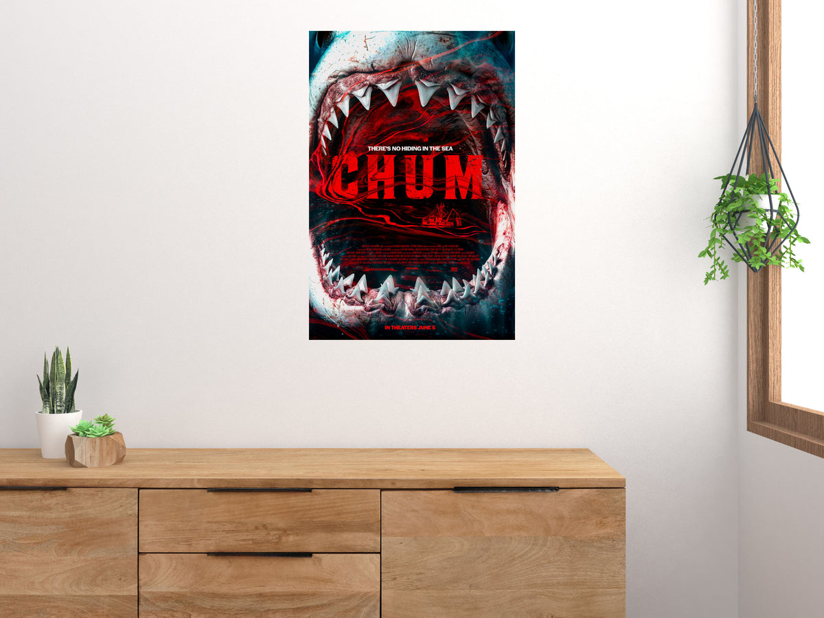 CHUM shark poster displayed above a wood sideboard in a bright room with houseplants