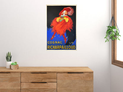 Cognac Richarpailloud poster displayed above a wood sideboard in a bright room with houseplants