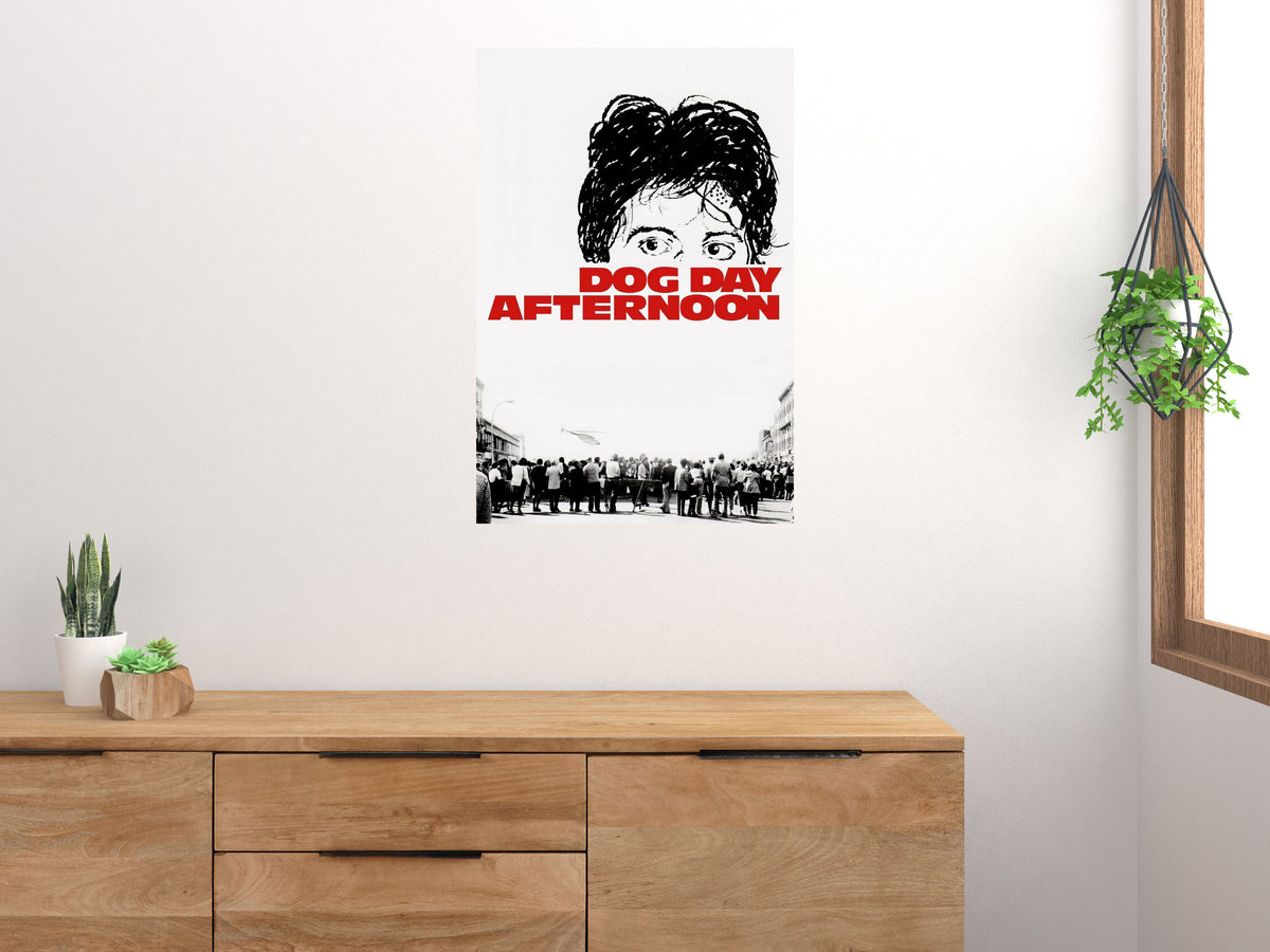 Dog Day Afternoon red title poster displayed above a wooden sideboard beside houseplants and a window