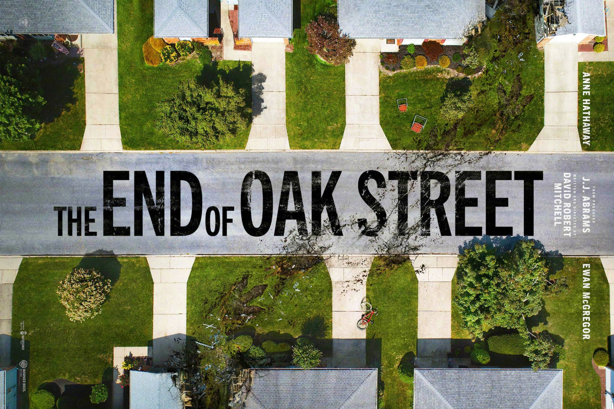 The End of Oak Street horizontal movie poster showing an aerial suburban neighborhood with green lawns, a damaged street and large black title lettering
