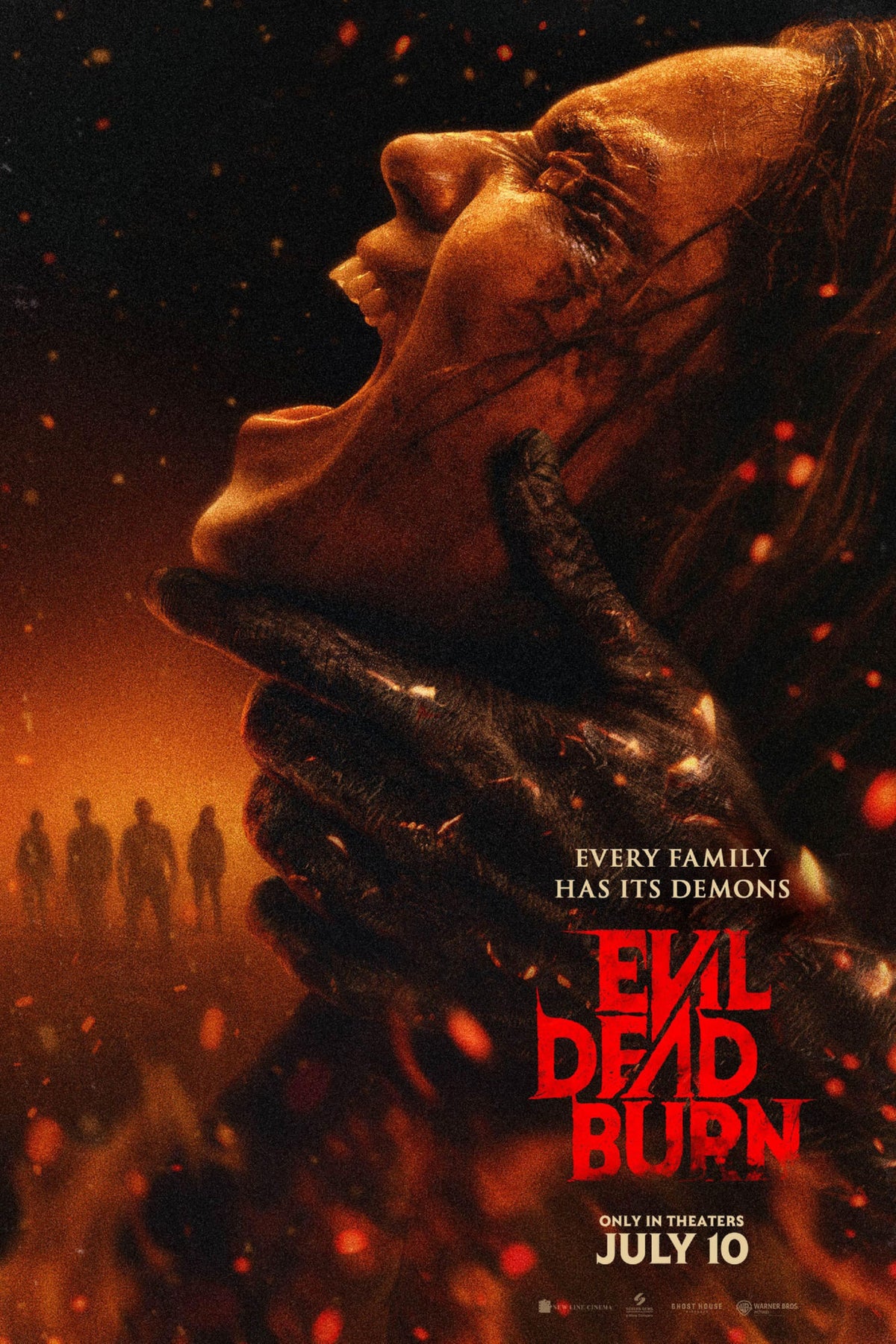 Evil Dead Burn movie poster showing a screaming profile gripped by a dark clawed hand amid orange embers and red title lettering