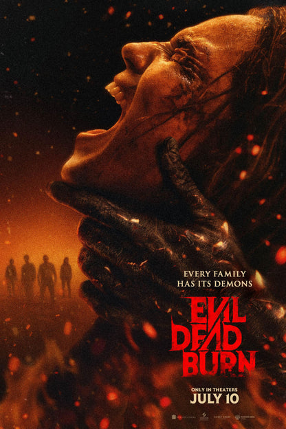 Evil Dead Burn movie poster showing a screaming profile gripped by a dark clawed hand amid orange embers and red title lettering