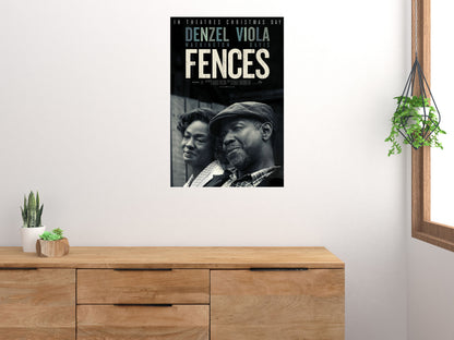 Fences vertical movie poster displayed above a wooden cabinet on a light wall
