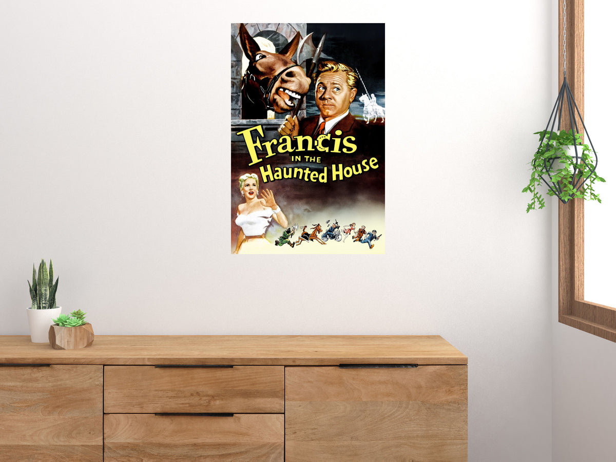 Francis in the Haunted House movie poster displayed vertically above a wooden cabinet on a light wall